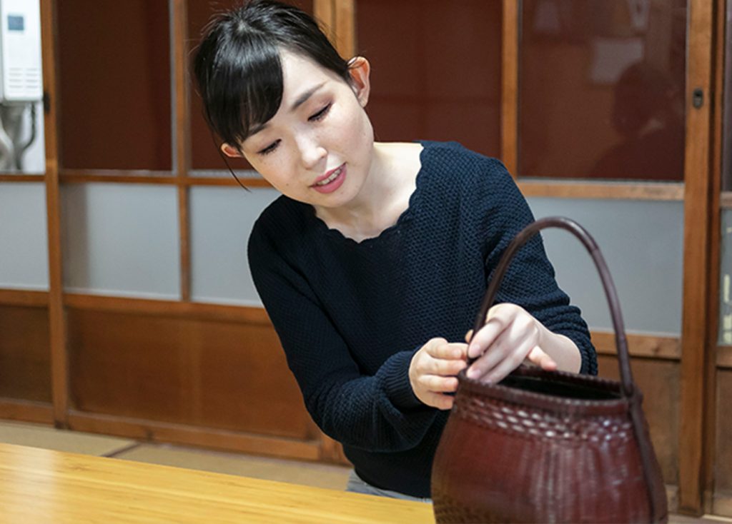 Ms. Ogura holding her craftwork