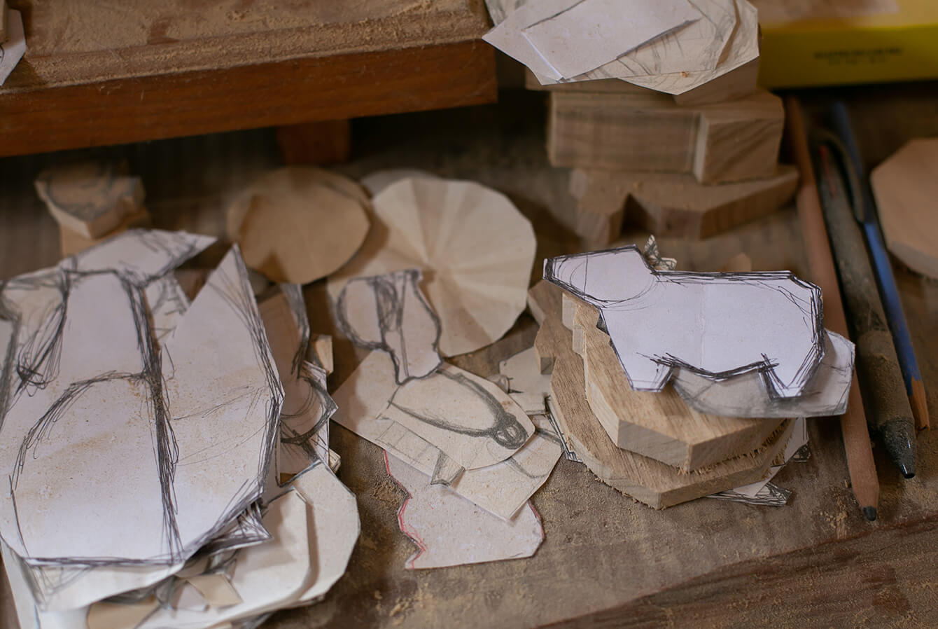 She cuts the pieces of wood to follow her hand-drawn designs